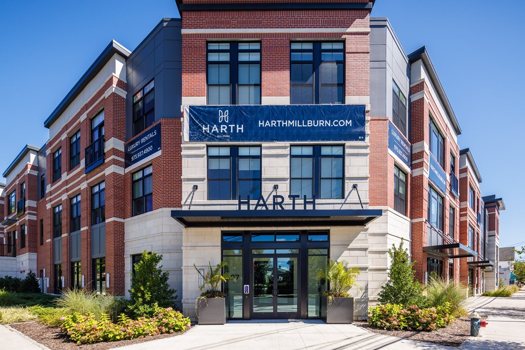 The front of a brick building with the name "HARTH" on it.