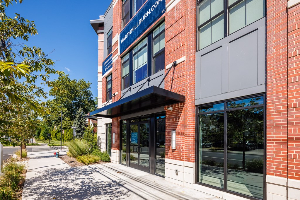 A brick building with a blue sign that says "Harmonyville Community College".