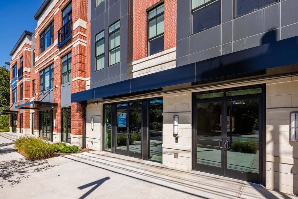 A modern building with a combination of brick and glass facade.