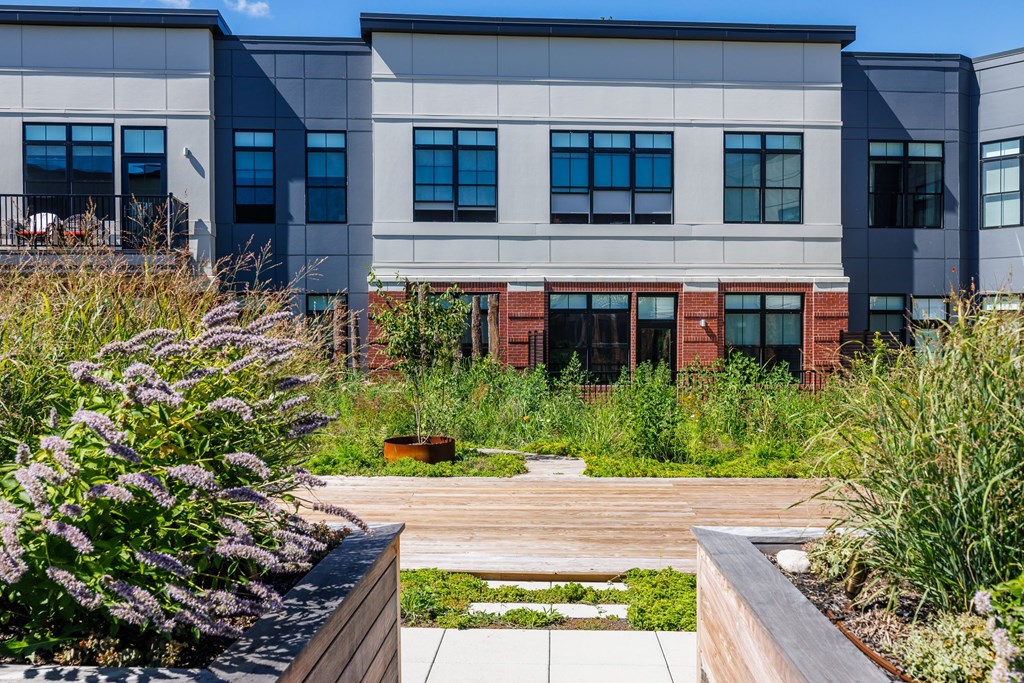 A modern building with a garden in front.