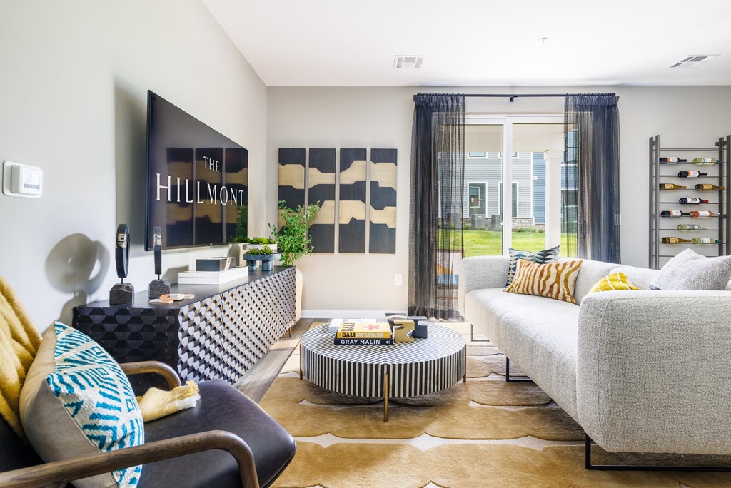 a living room with a white couch and a black and white coffee table