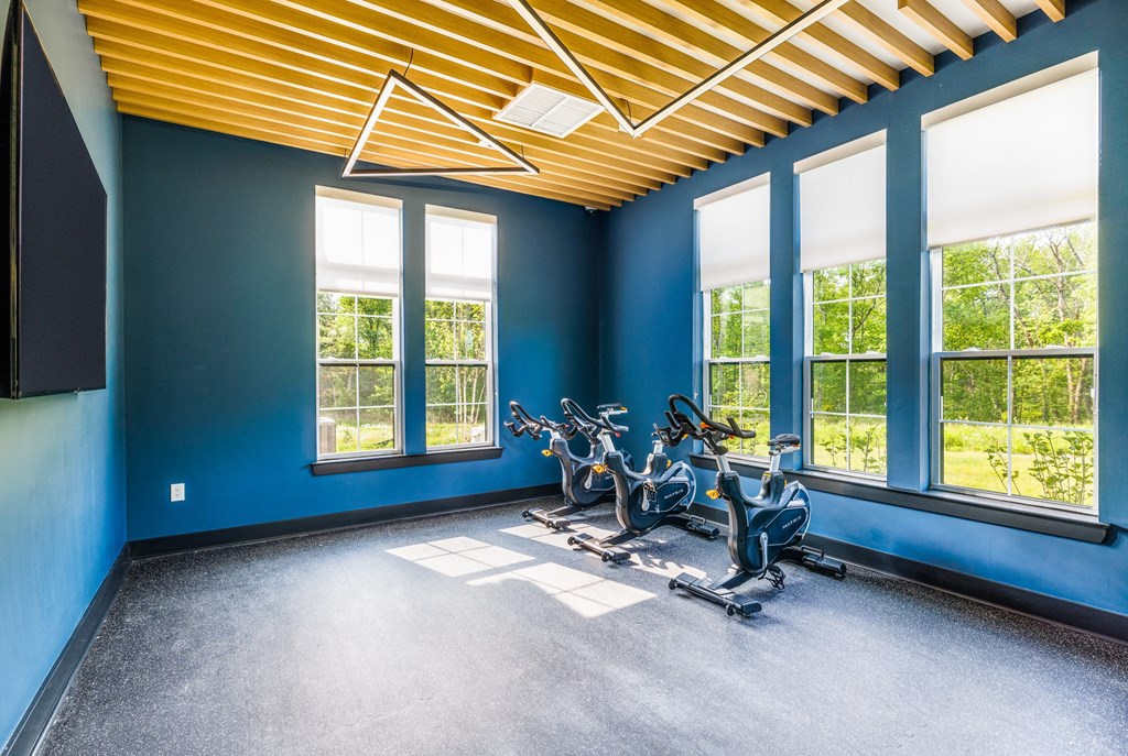 an exercise room with blue walls and a yellow ceiling
