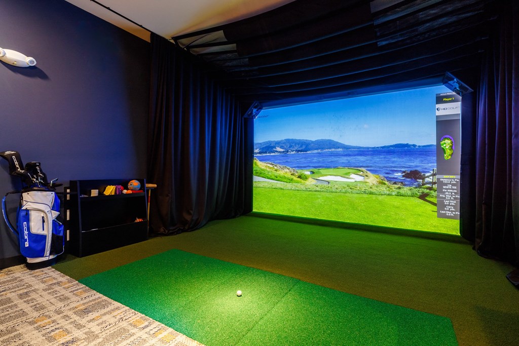 a golf simulator with a view of the ocean