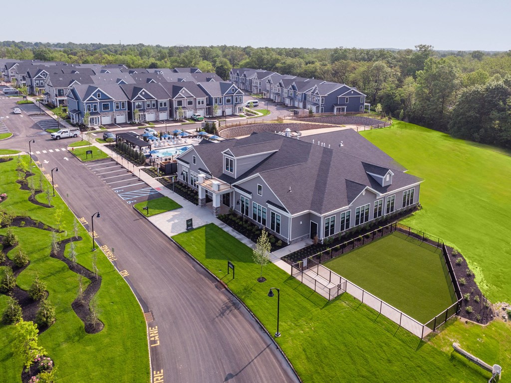 an aerial view of a large house with a pool in front of it