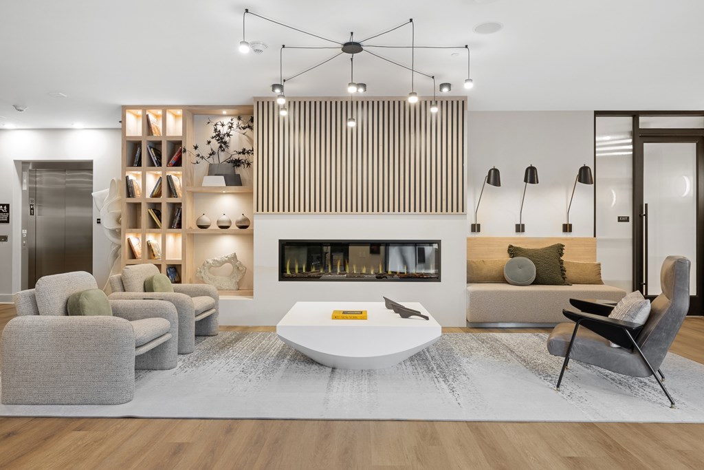 A modern living room with a fireplace and a grey sofa.