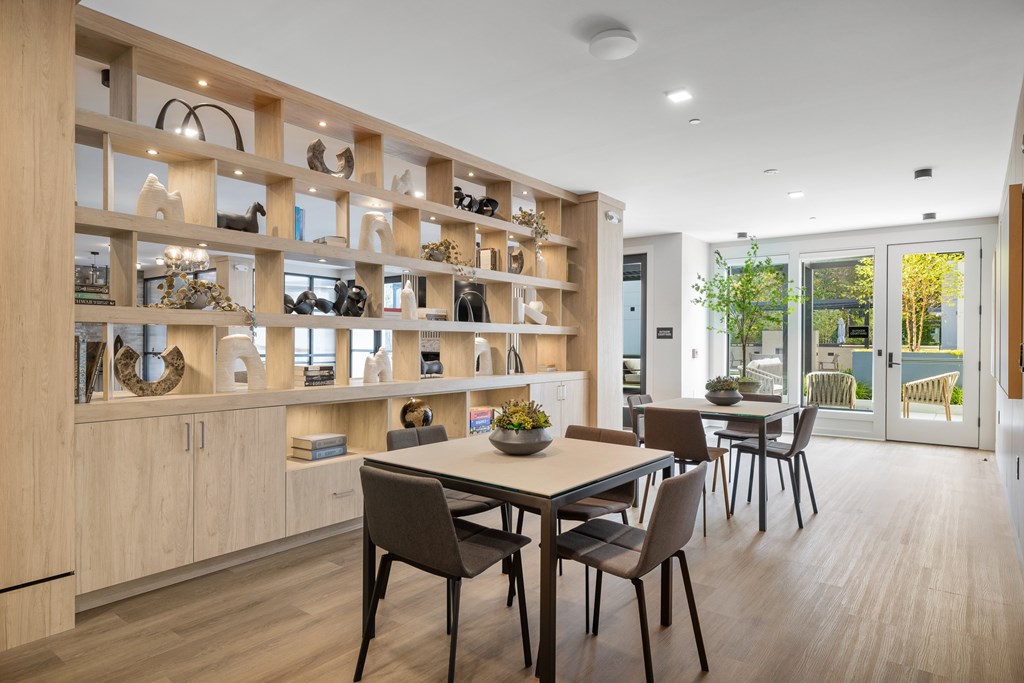 A modern dining room with a wooden table and chairs.