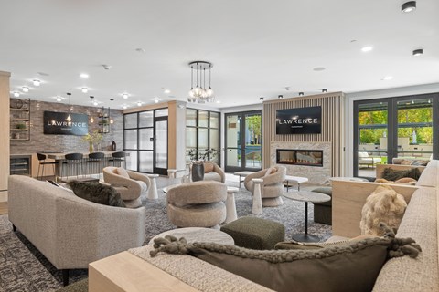 A modern living room with a large couch and a fireplace.