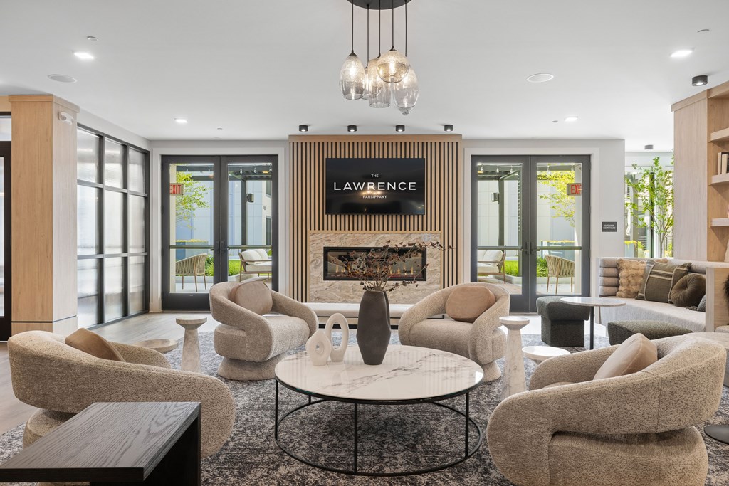 A living room with a fireplace and a sign that says "Lawrence".