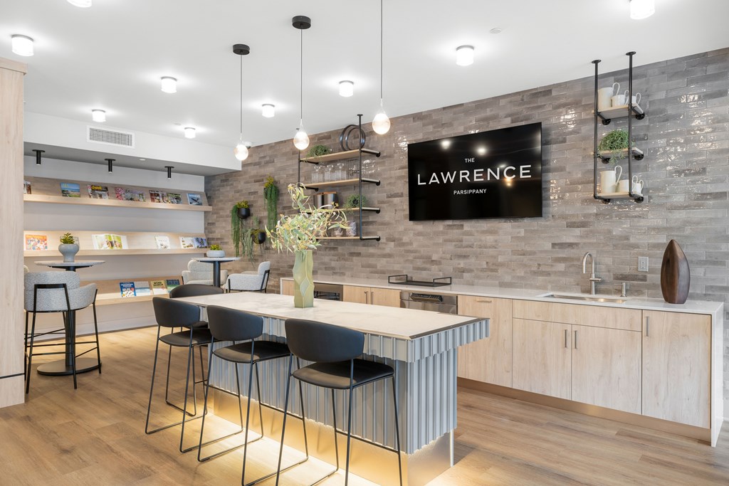 A modern kitchen with a bar area and a sign that reads "LAWRENCE".