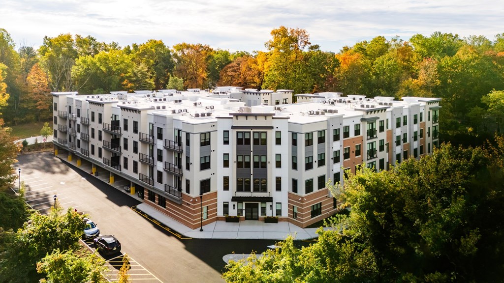 A large white building with a parking lot in front of it.