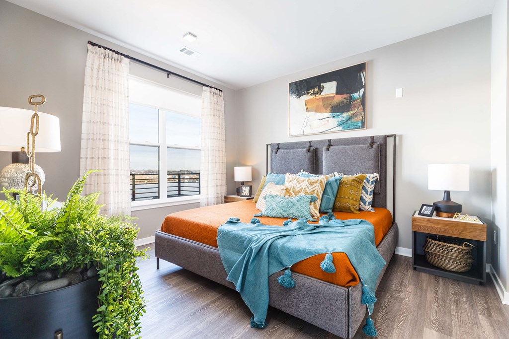 a bedroom with a bed and a large window