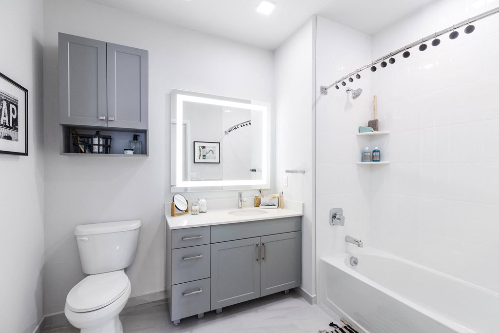 a white bathroom with a toilet sink and shower