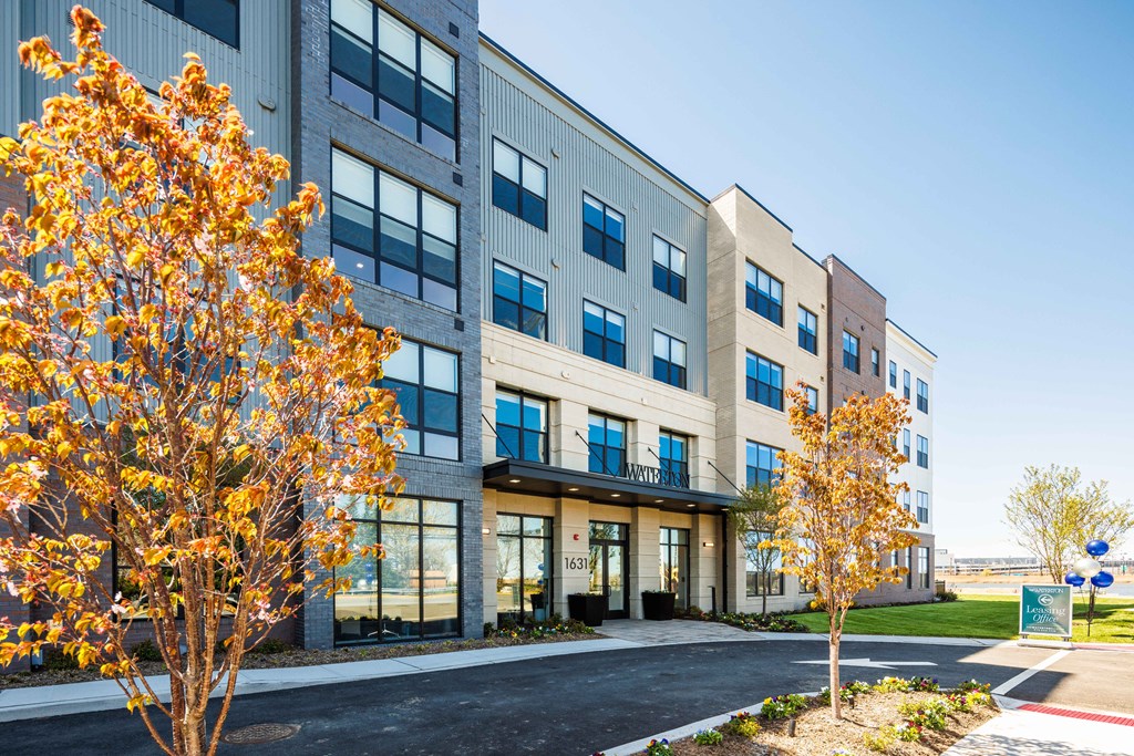 an exterior view of a building with trees in front of it