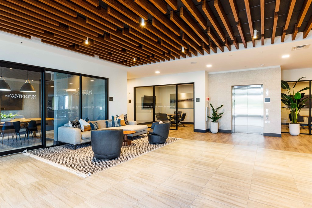 a living room with a couch and chairs in a lobby