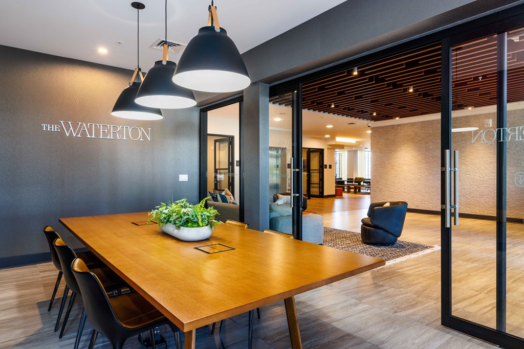 a dining room with a wooden table and chairs