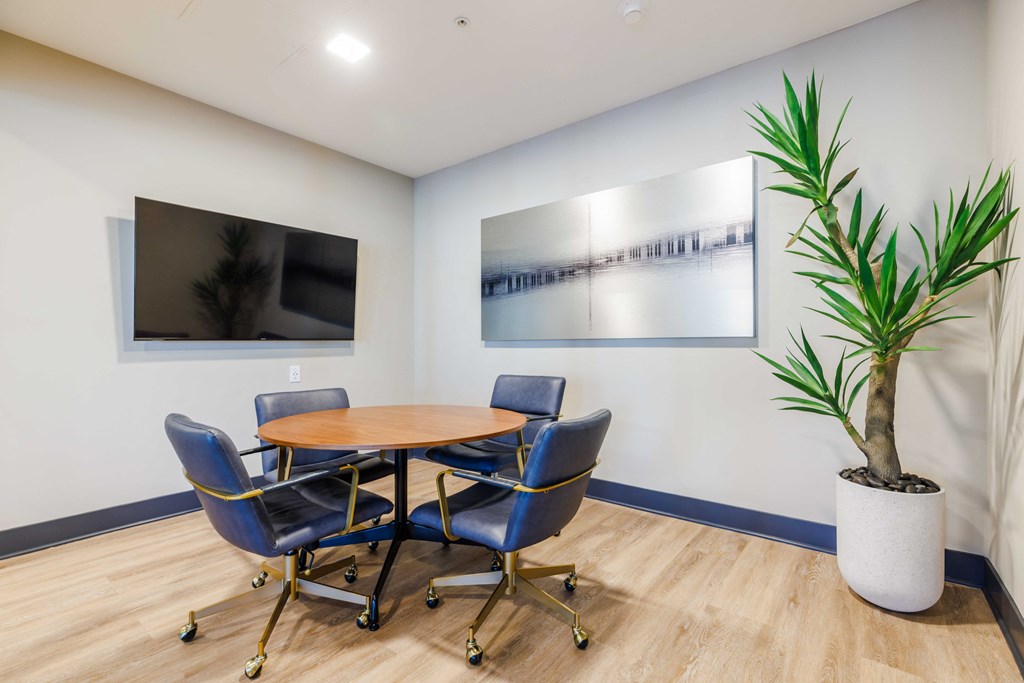 a conference room with a wooden table and blue chairs
