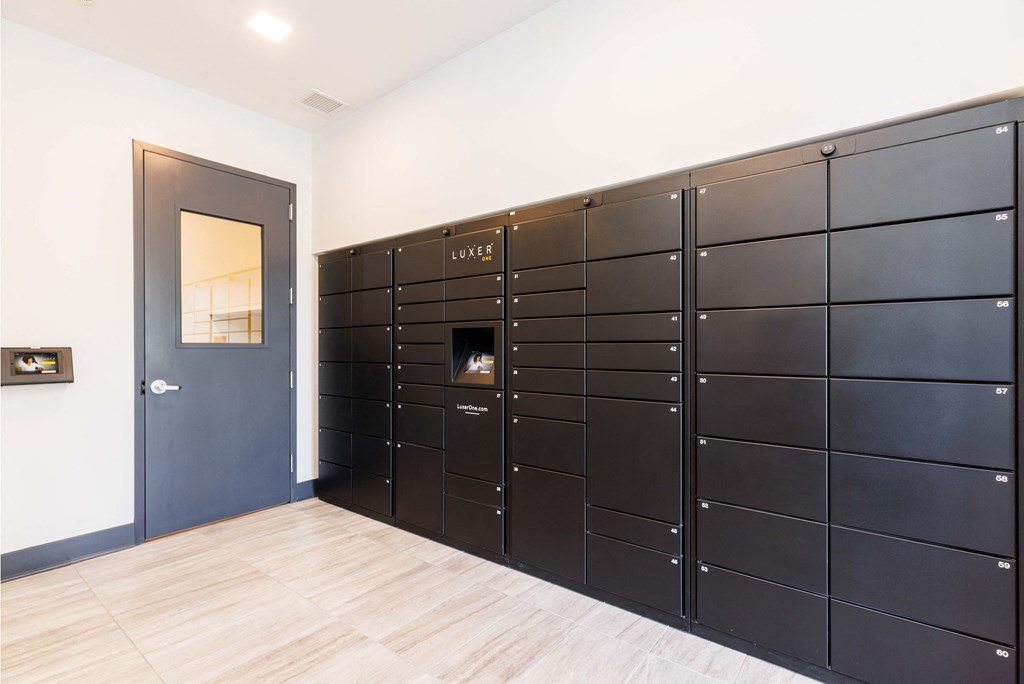 a large set of lockers in a room with a door