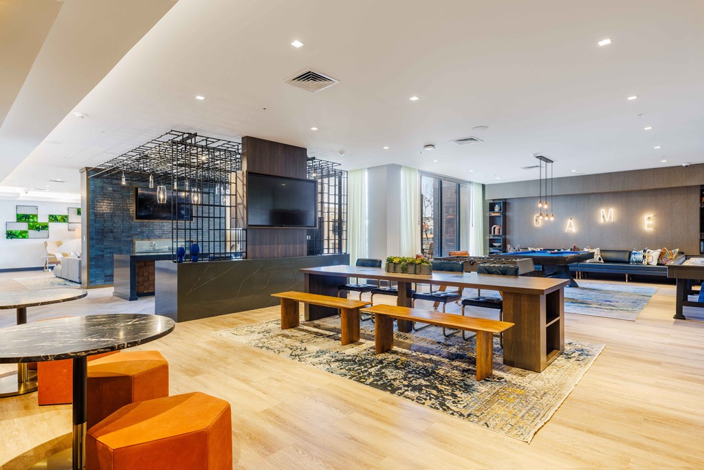 a living room and dining room with a table and chairs