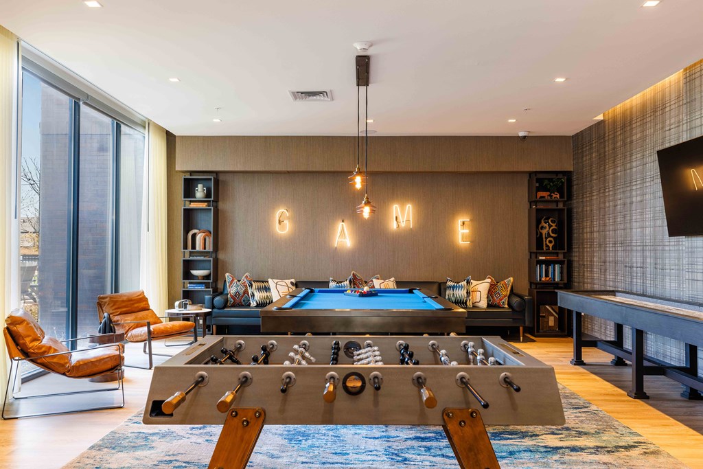 a game room with a foosball table and a pool table