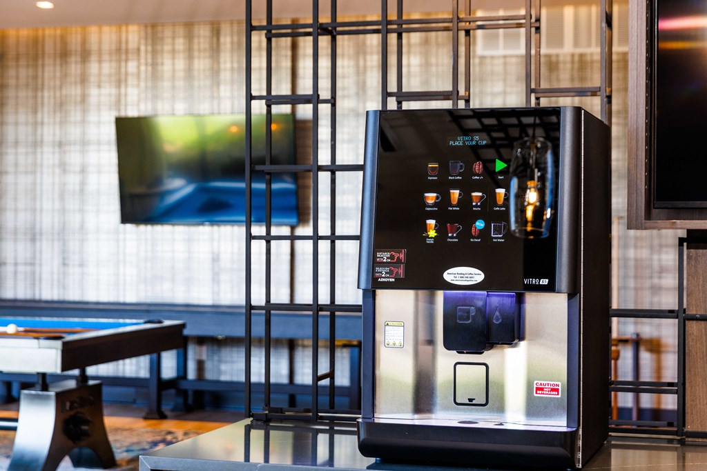 a vending machine in a hotel lobby with a television