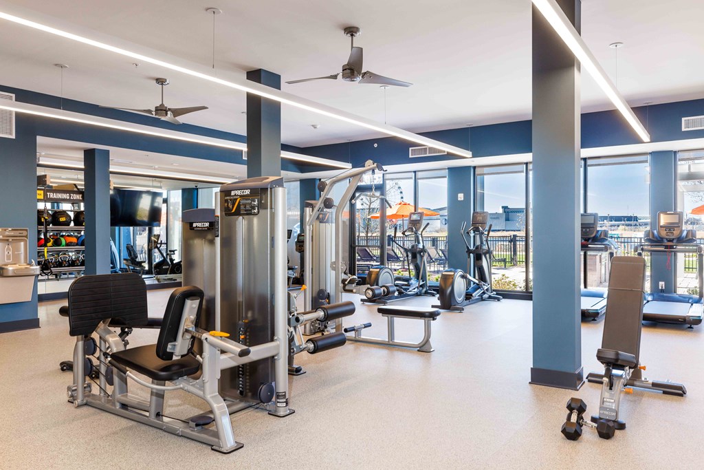 A gym with a variety of equipment including weights and machines.