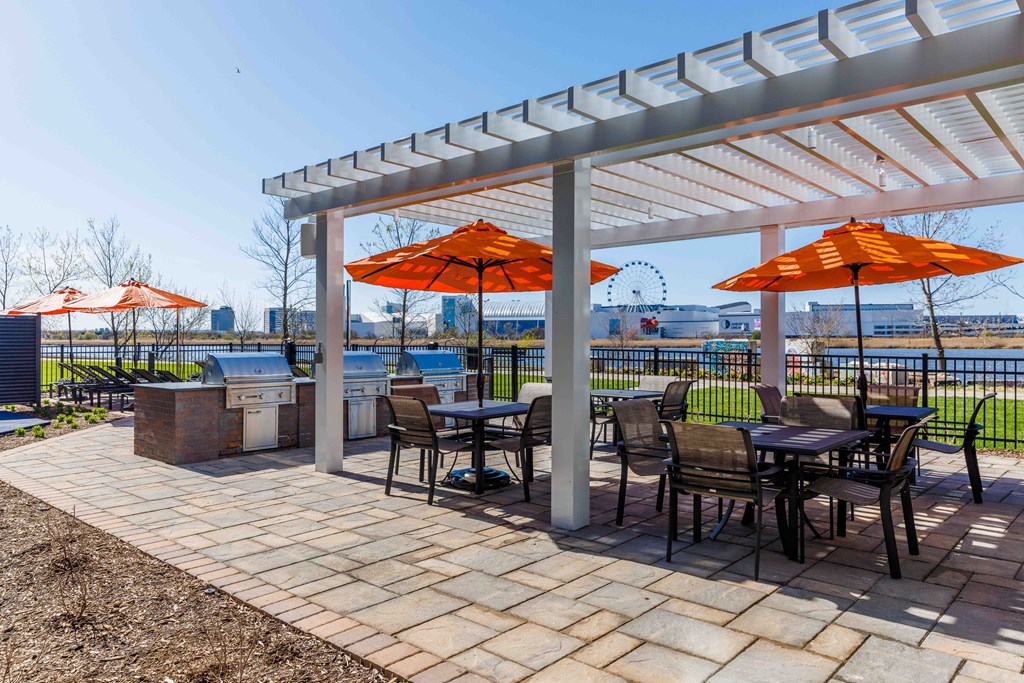 a patio with tables and chairs and orange umbrellas