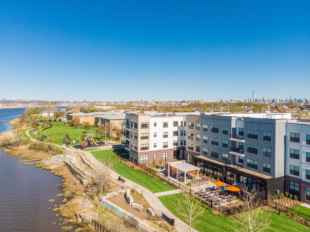 an aerial view of an apartment building overlooking the water