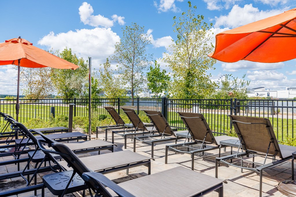 A row of chairs and tables are set up on a patio.
