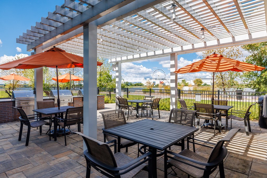 A patio with a table and chairs under a pergola.