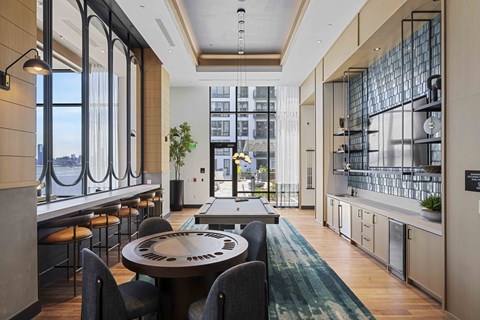 A modern kitchen with a dining table and chairs.