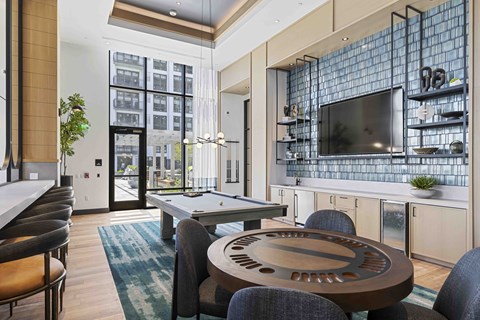 A modern dining room with a glass table and chairs.