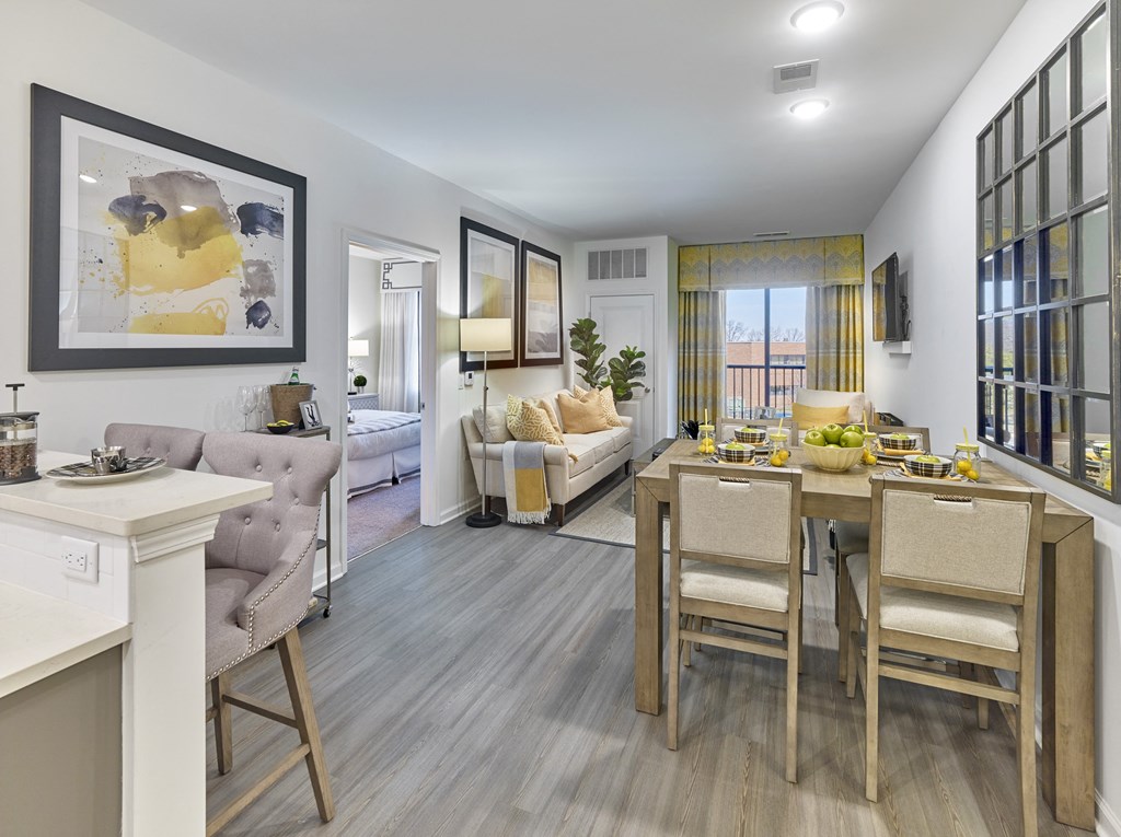 a living room and dining room with a table and chairs