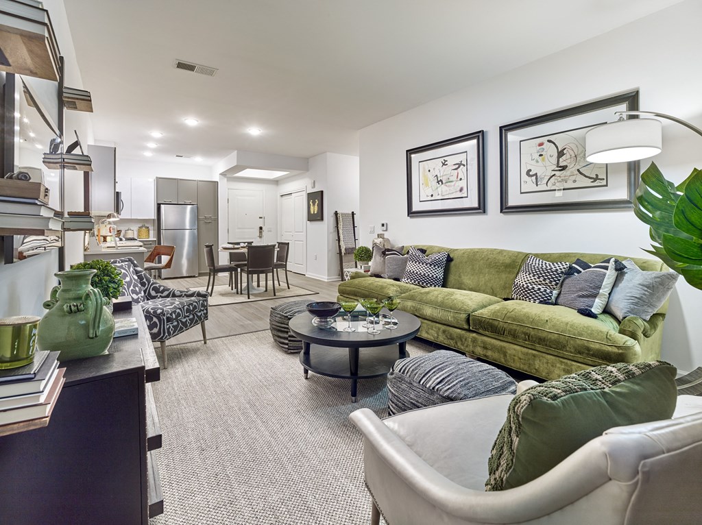 a living room with a green couch and a table
