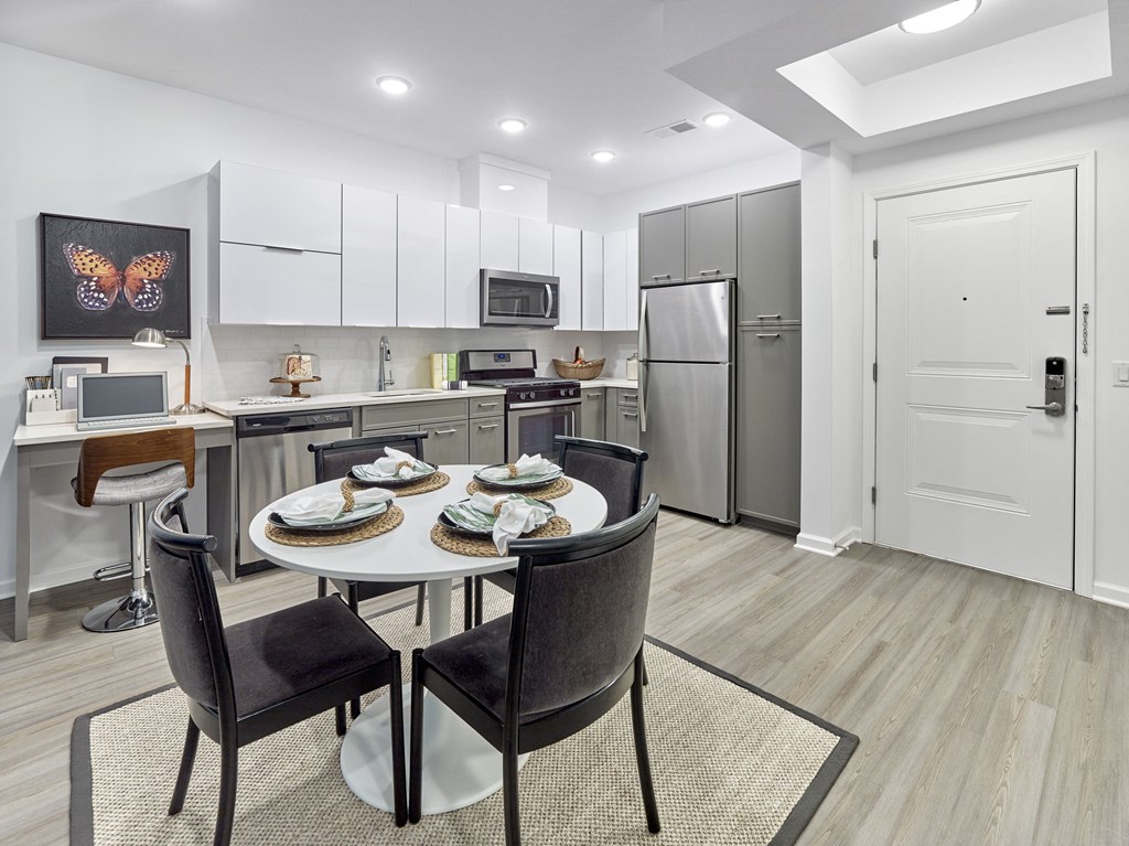 a kitchen and dining room with a table and chairs