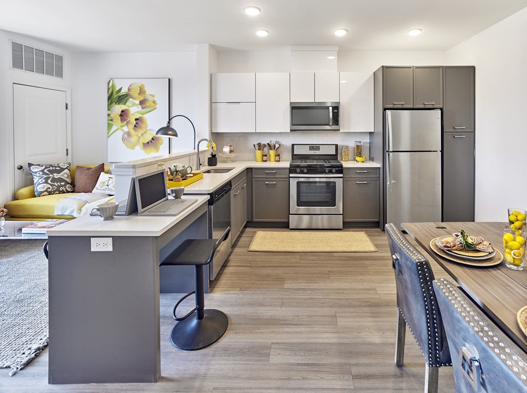 a kitchen and dining room with stainless steel appliances and a table