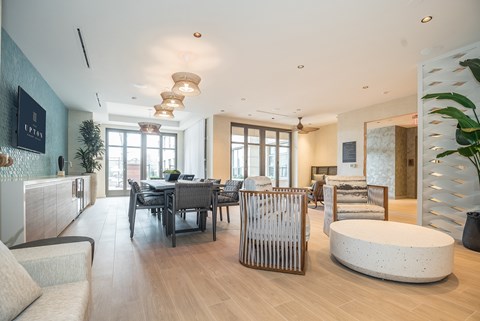 A modern living room with a dining table and chairs.