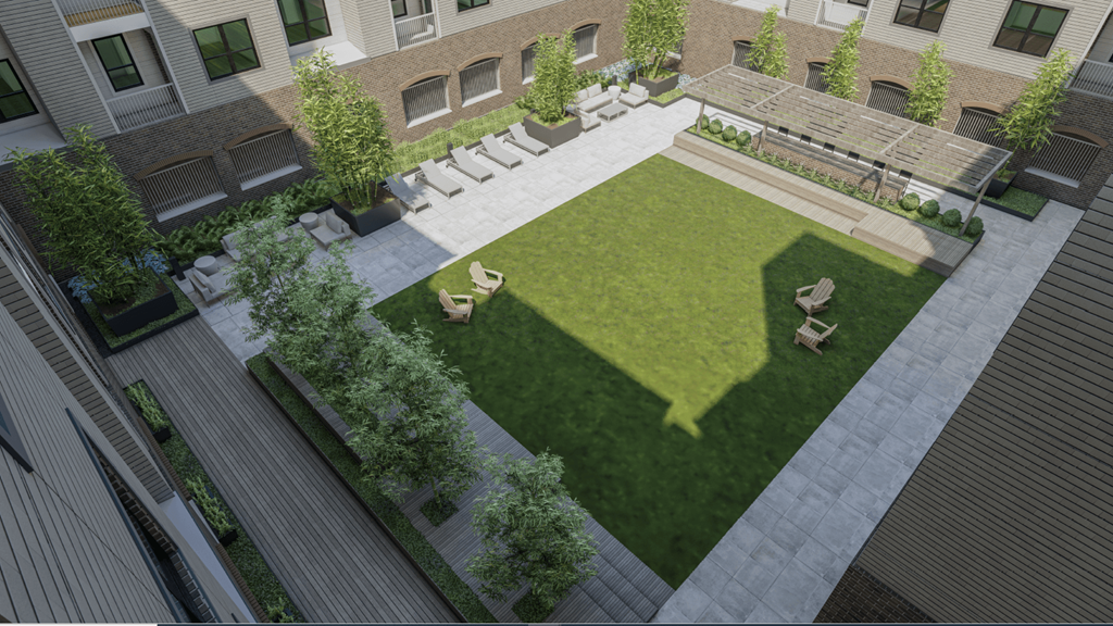 A courtyard with a grassy area and a bench.