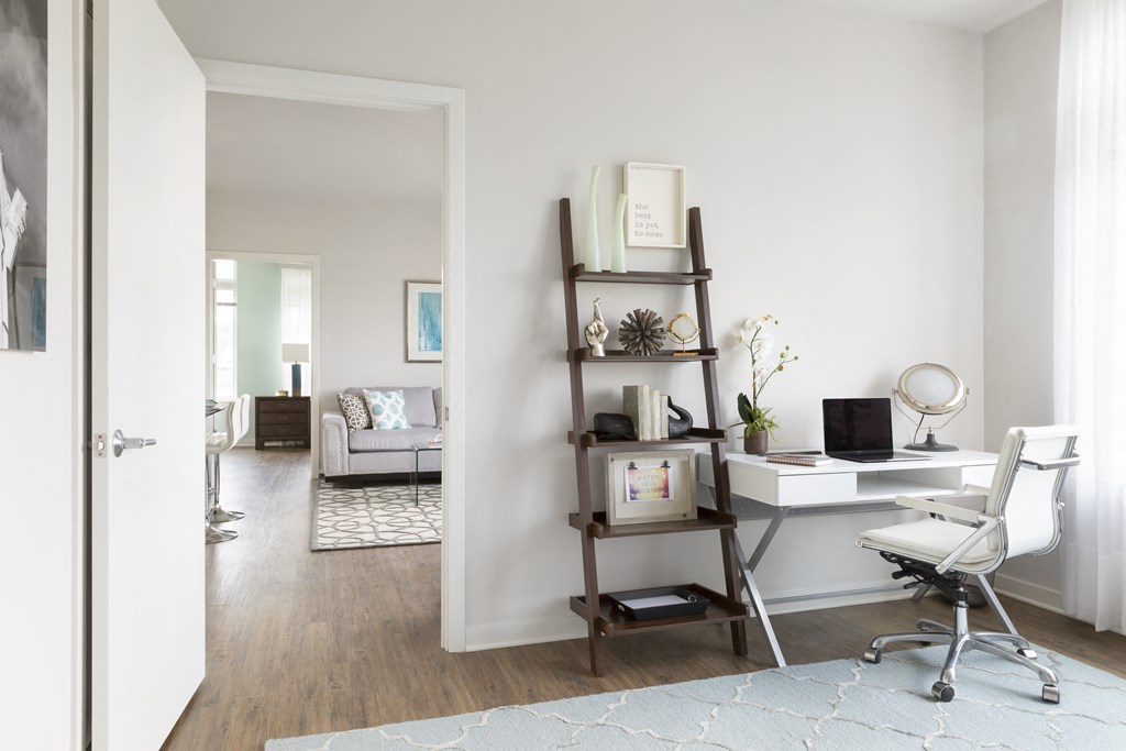 a home office with a desk and a chair and a book shelf