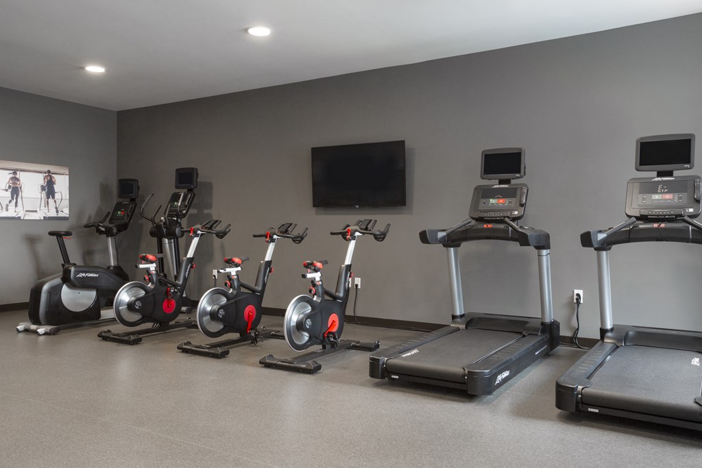 a row of exercise bikes in a gym