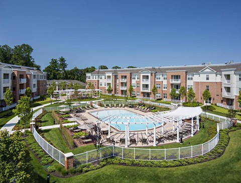 Aerial view of pool courtyard with white pergola and landscaping at Highlands at Hilltop Apartments, Verona, NJ