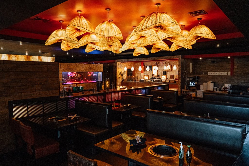 A restaurant with a dark interior and wooden furniture.