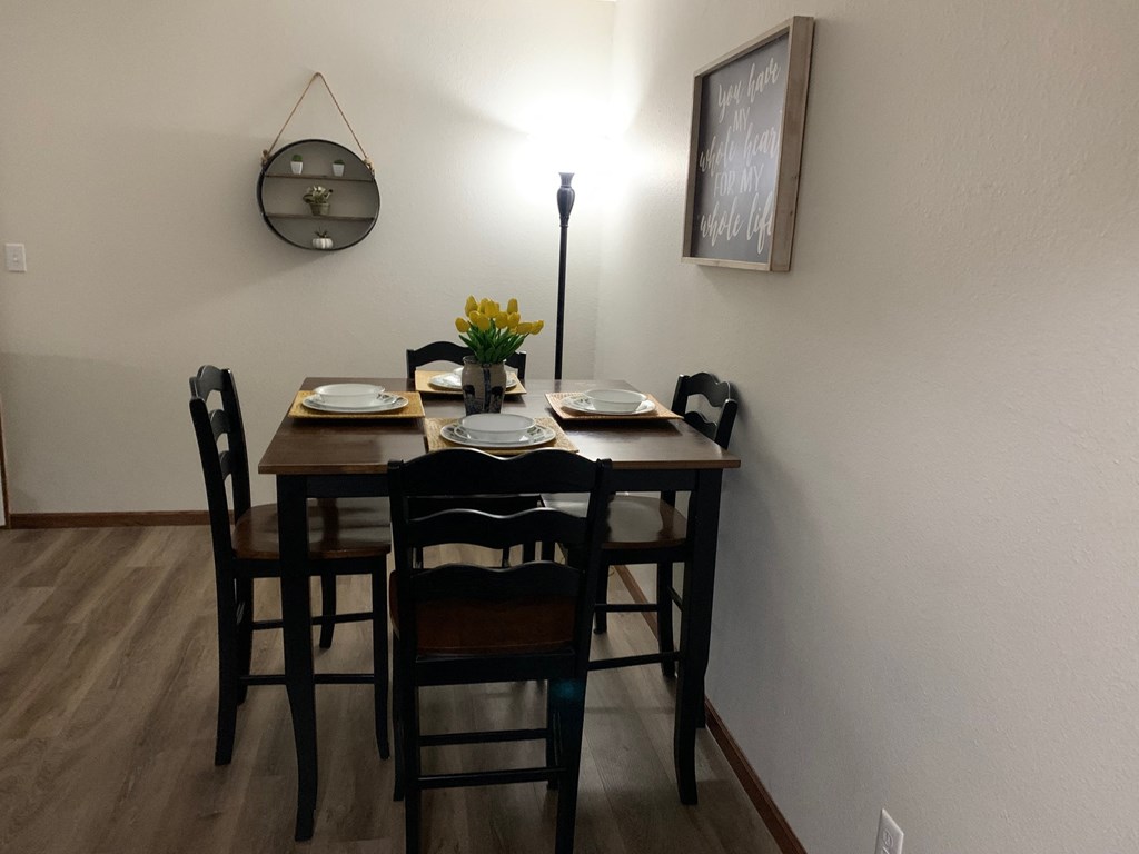 a dining room with a wooden table and chairs