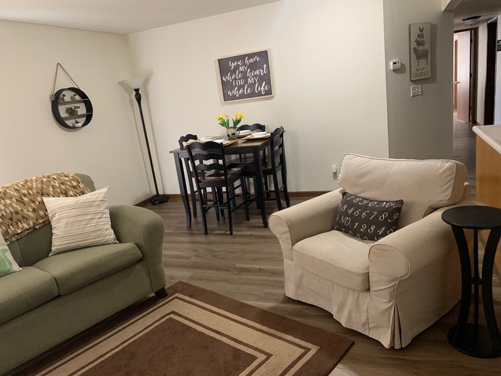 a living room with a couch and a chair and a table