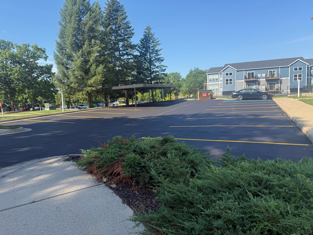 A parking lot with a building in the background.