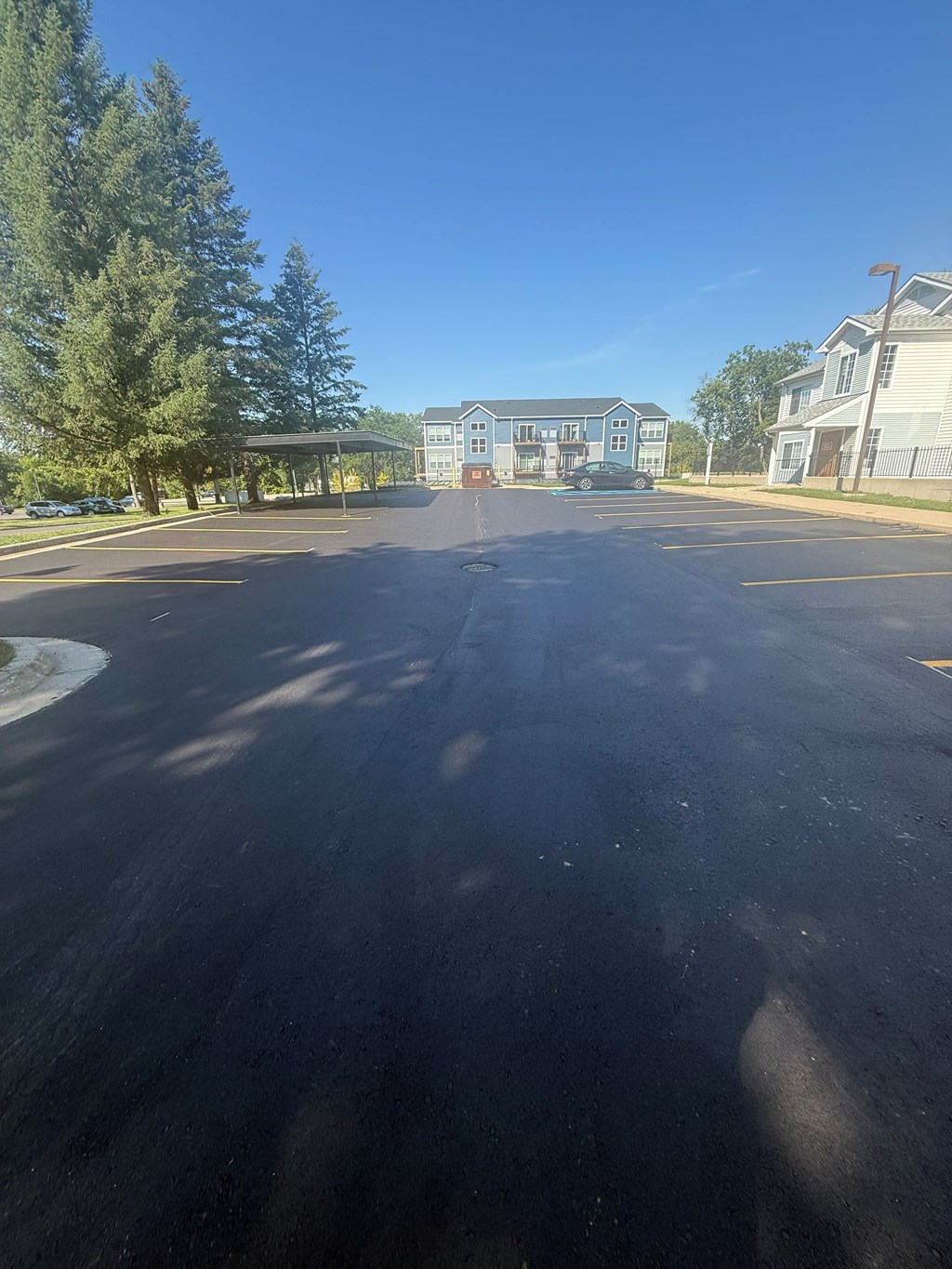 A parking lot with a building in the background.