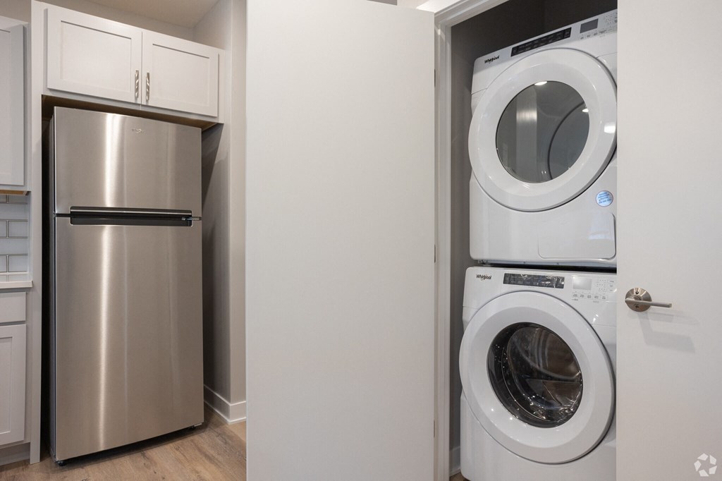 A white washing machine is in a doorway.