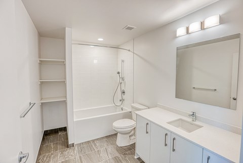 a bathroom with a shower and a sink and a toilet