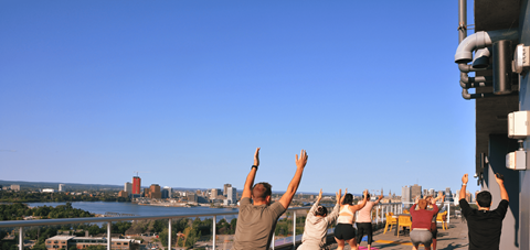 a group of people with their hands in the air at the top of a tower