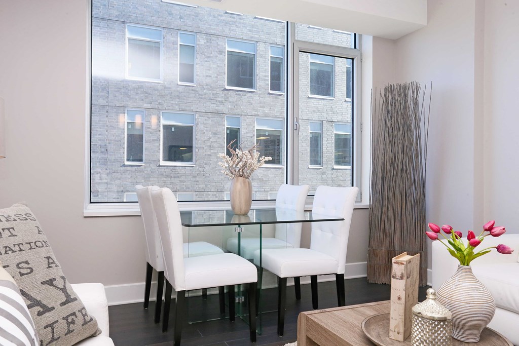 a dining room with a glass table and white chairs