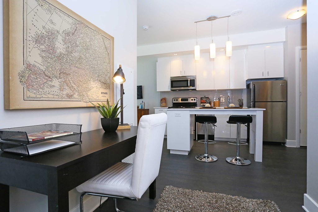 a kitchen and dining room with white cabinets and stainless steel appliances